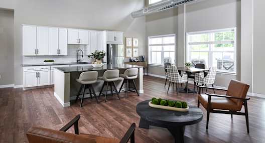 A modern kitchen with a dining table and chairs.