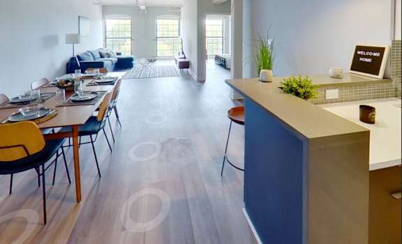 a dining room and living room with a table and chairs