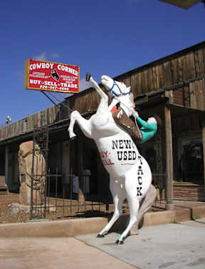 A large statue of a horse with the words "newly used tack" written on it.