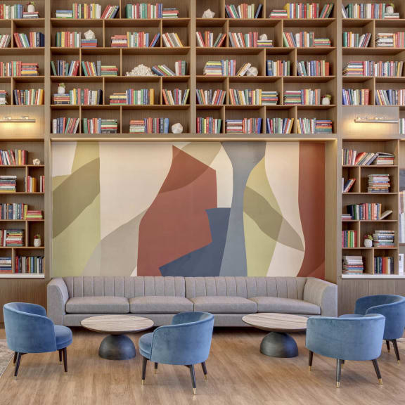 a library with a couch and tables at BLVD Beltline, Calgary, Alberta, T2G 2K4