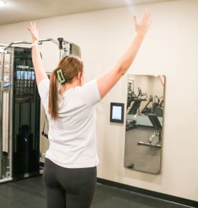 a woman standing in a gym with her arms in the air  at Timber Ridge, Minnesota