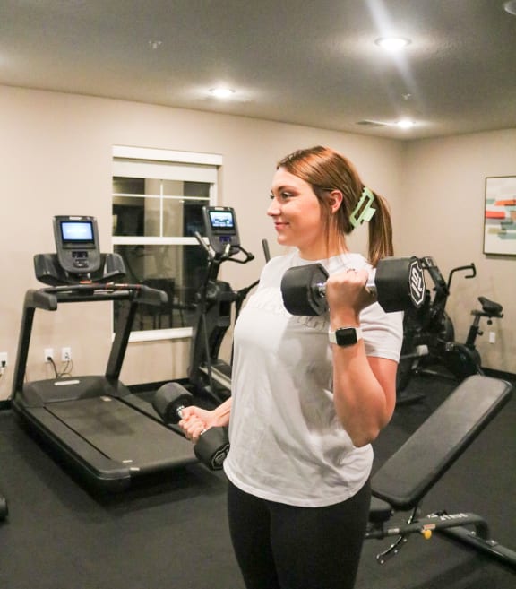 a woman doing a dumbbell workout in a gym  at Timber Ridge, Forest Lake, 55025