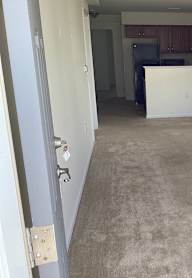 an empty living room with two windows