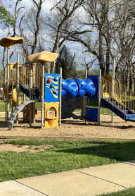 a playground with a blue and yellow playset