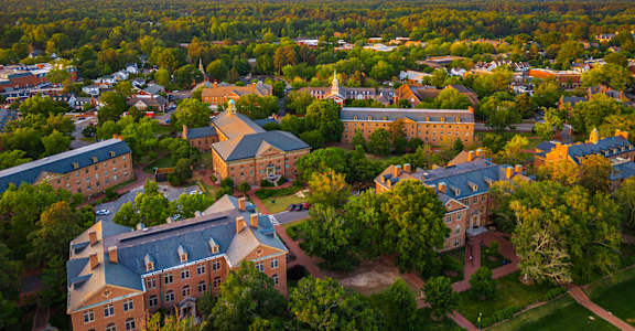 A beautiful aerial view of a campus with buildings and trees.