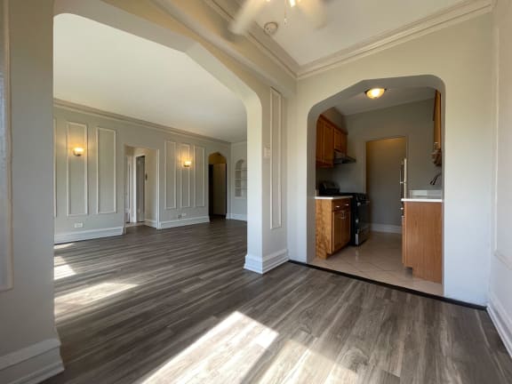 a large living room with a kitchen in the background at 1033 W Loyola, Chicago