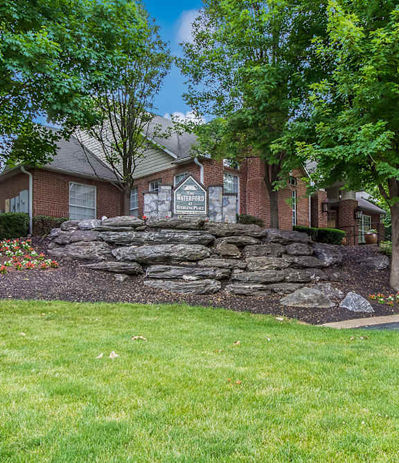 a stone retaining wall in front of a house