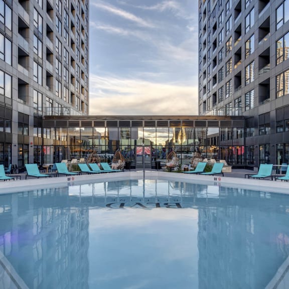 a swimming pool in front of a building with tall buildings at BLVD Beltline, Calgary, Alberta, T2G 2K4