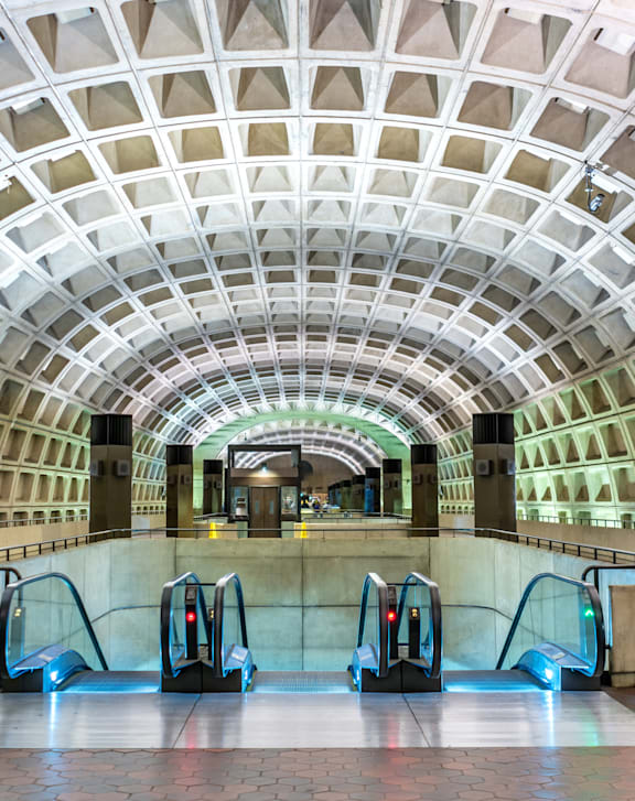 A subway station with a white ceiling and a row of escalators.at Summerland Heights, Woodbridge Virginia