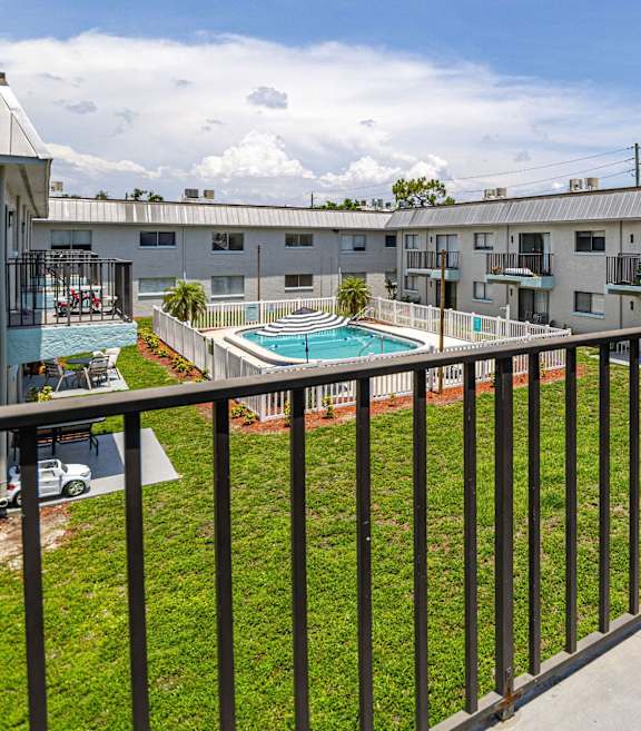 a view of the pool from a balcony at the resort