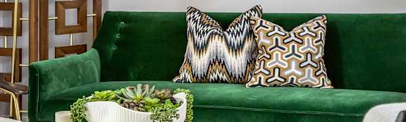 A living room with a green couch and a coffee table.