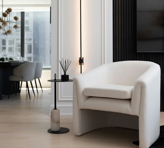 a white chair in a living room with a table and a television at Chateau on Wells, Chicago, Illinois