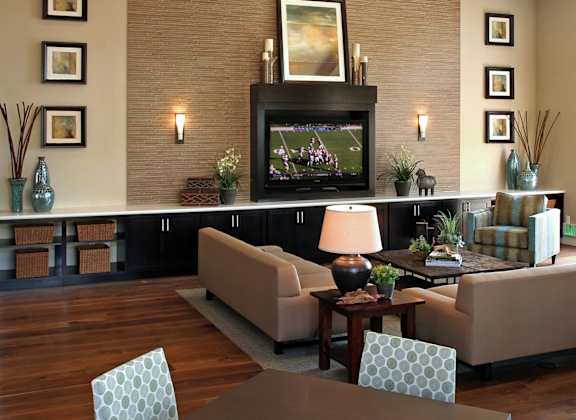 A living room with a fireplace and a television.