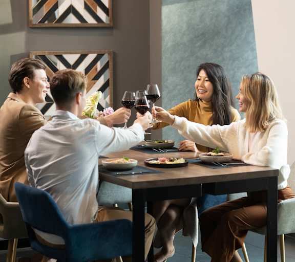 happy group of people enjoying a drink at a table