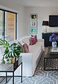 A modern living room with a large window and a painting on the wall.at Ten Select Apartments, Arlington, Virginia