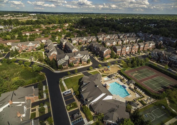 an aerial view of a neighborhood with houses and a pool at Mainstreet Village, Novi, MI, 48375