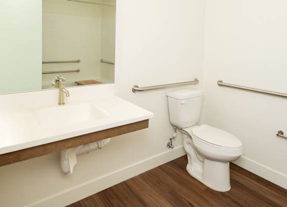 A white toilet sits next to a sink in a small bathroom.