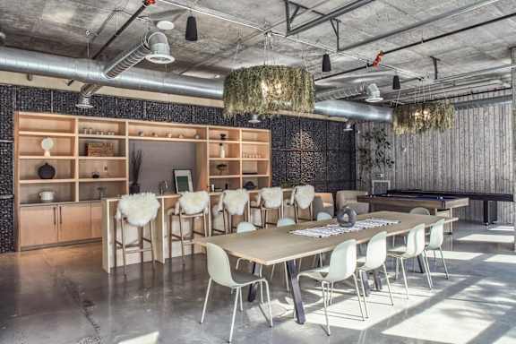 A conference room with a long table and chairs.