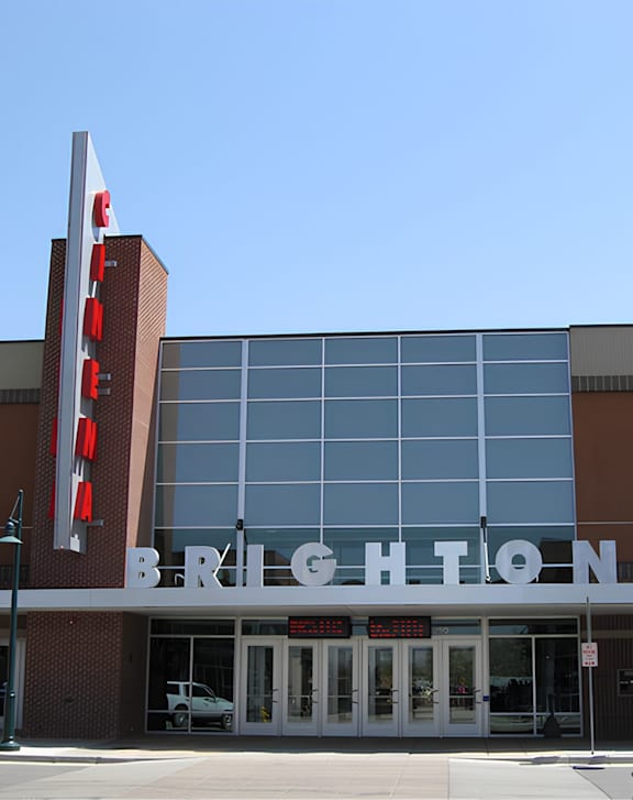 A street view of Legal Cinemas 16 with a clear sky above.