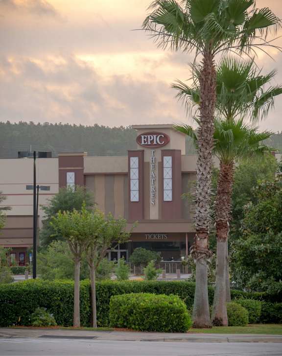 A street view of Legal Cinemas 16 with a clear sky above.