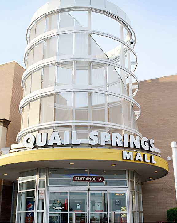 A street view of Legal Cinemas 16 with a clear sky above.