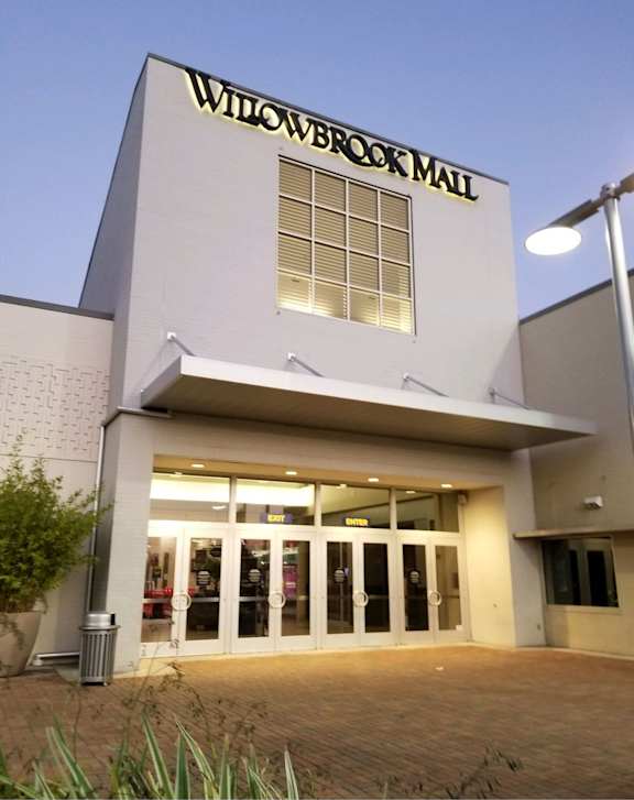 A street view of Legal Cinemas 16 with a clear sky above.