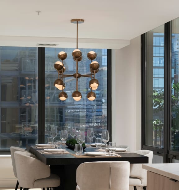 a dining room with a table and chairs and a large window at Chateau on Wells, Chicago, Illinois