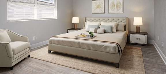 a bedroom with a bed and a chair and a window