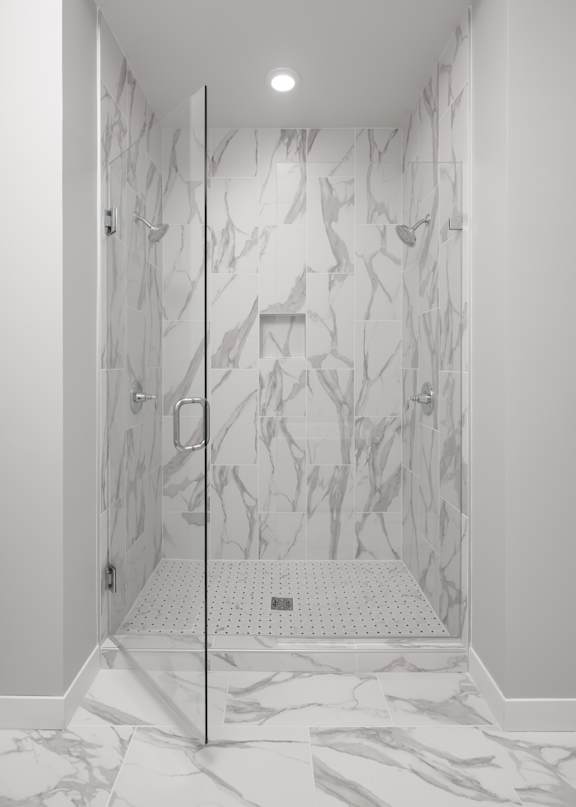 the shower in the master bathroom in a home with a marble shower floor and wall at Expo, Minneapolis, 55414