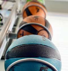 a row of basketballs on a rack