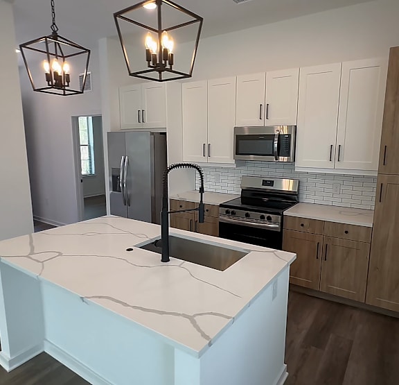 a living room with a couch and a table at The Hadley Luxury Apartments, North Port, FL