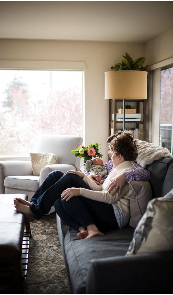 a couple sitting on a couch in a living room
