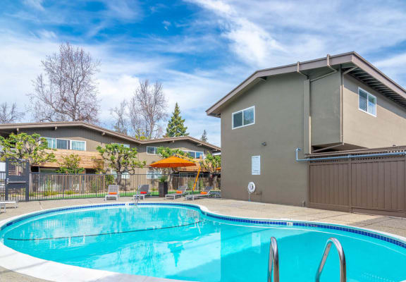a swimming pool with a house in the background at Element LLC, Sunnyvale, 94086