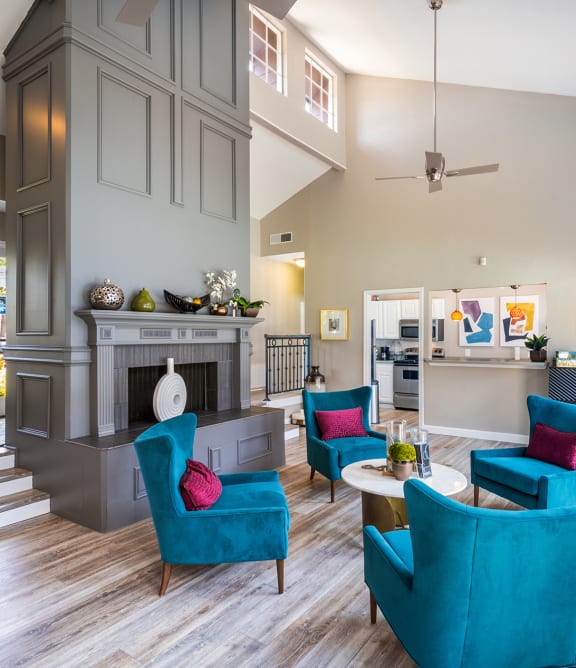 Leasing Office with blue chairs and a fireplace at Noel on the Parkway in Dallas, TX
