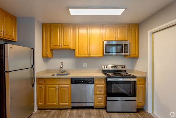 a kitchen with a sink and a stove and a refrigerator