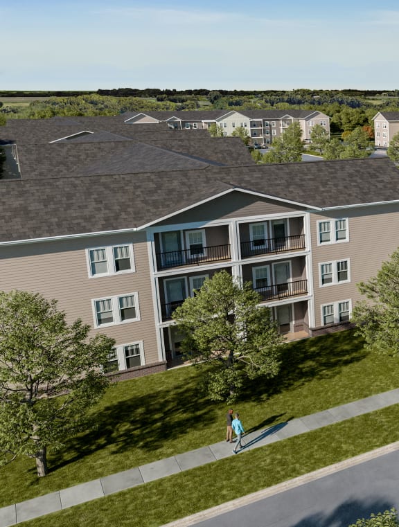 an aerial view of a large apartment complex with people walking on the street