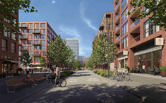 A street view of a city with people walking and biking.