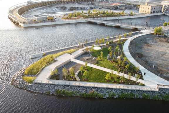 A circular island with a building in the middle surrounded by water.