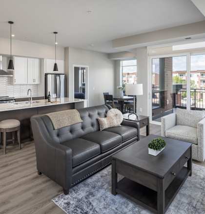 A modern living room with a grey sofa and a wooden coffee table.