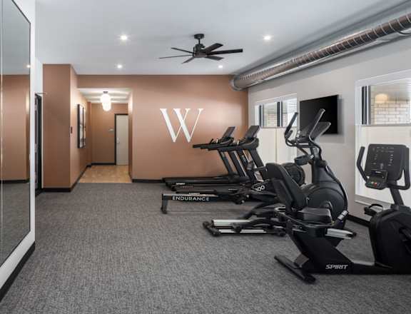 A gym with treadmills and exercise bikes.