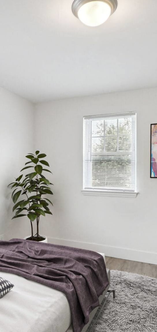 a bedroom with a bed and two windows