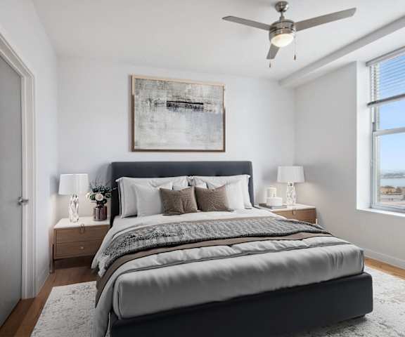 an image of a bedroom with a bed and a ceiling fan