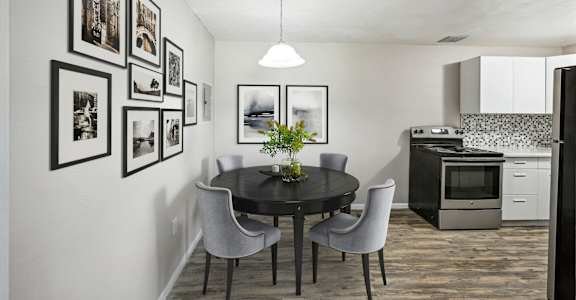 A kitchen and dining room with a table and chairs at Park at Fitzsimons Apartments, Colorado