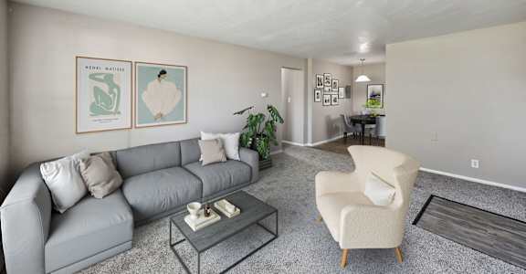 A living room with a couch and a coffee table at Park at Fitzsimons Apartments, Aurora