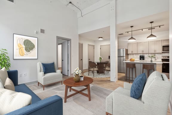 a living room and kitchen with couches and a table