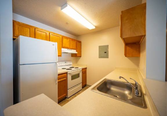 a kitchen with a sink and a refrigerator