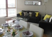 Thumbnail 6 of 6 - a living room and dining room with a glass table and couches
