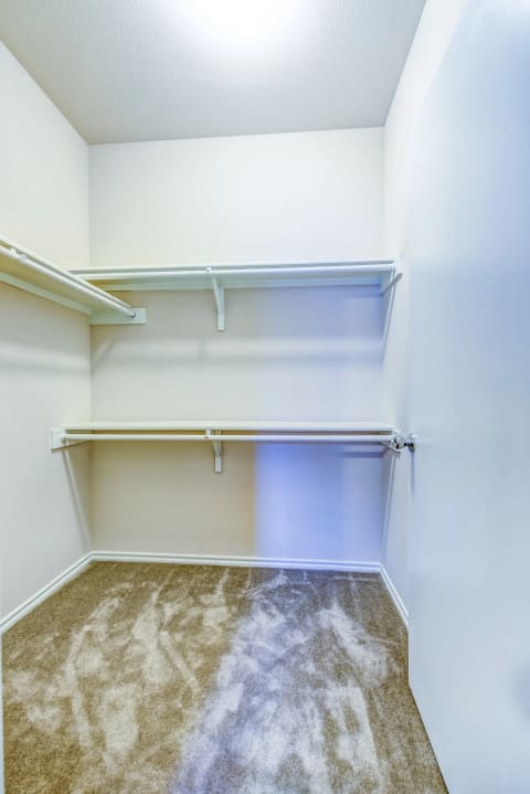 a walk in closet in a 555 waverly unit at Villa Espada Apartments, San Antonio, Texas