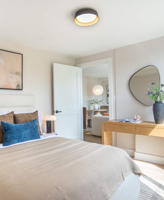 A bedroom with a large bed and a mirror on the wall.