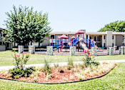 Thumbnail 11 of 39 - Playground with slides and swings at Riata Park community